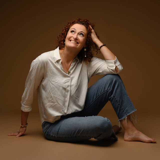 woman sitting on grey cliff